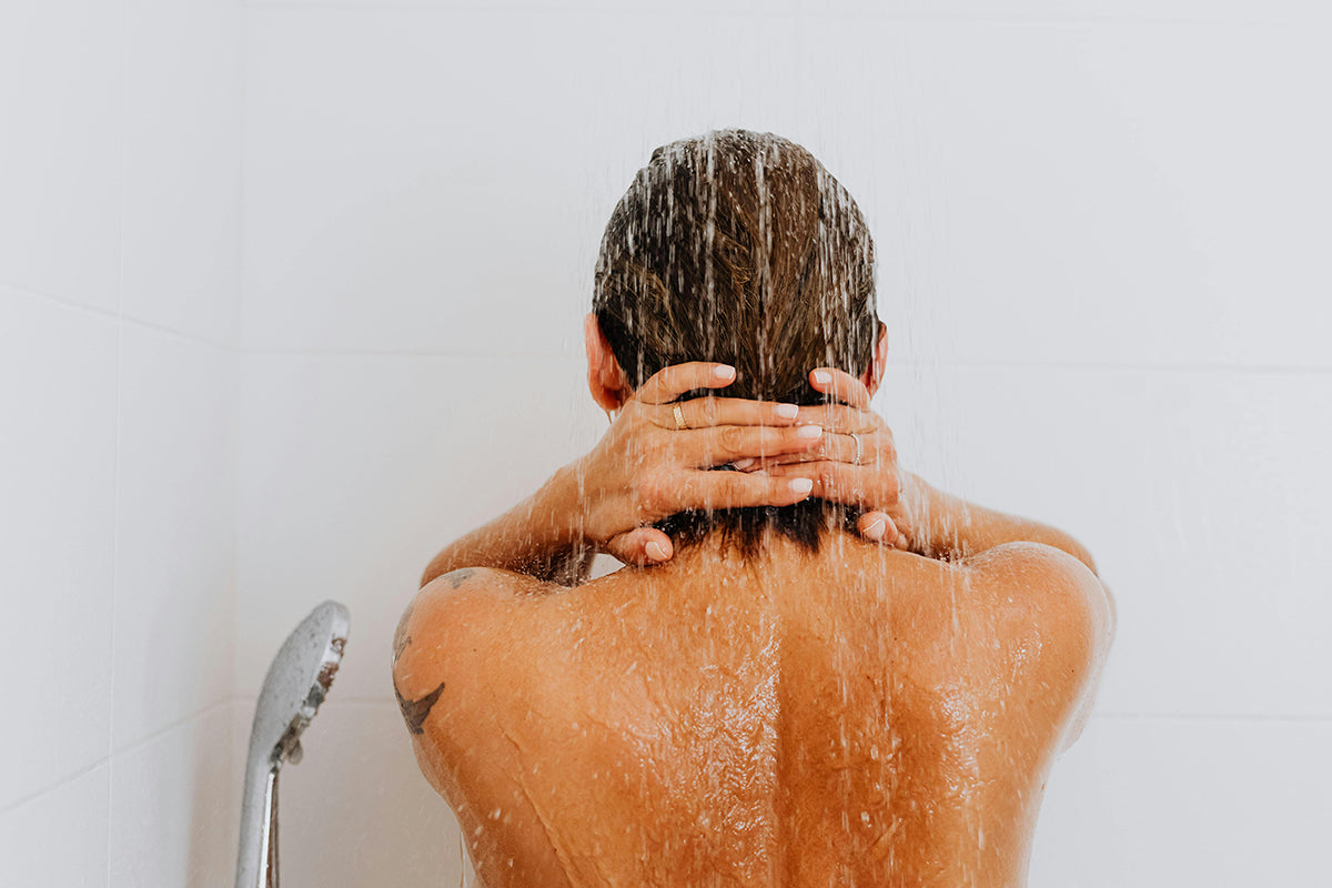 woman using filtera shower filter in the shower